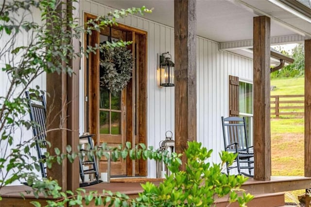 view of exterior entry with a porch