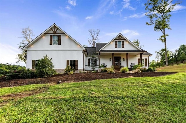 modern farmhouse featuring a front yard and a porch