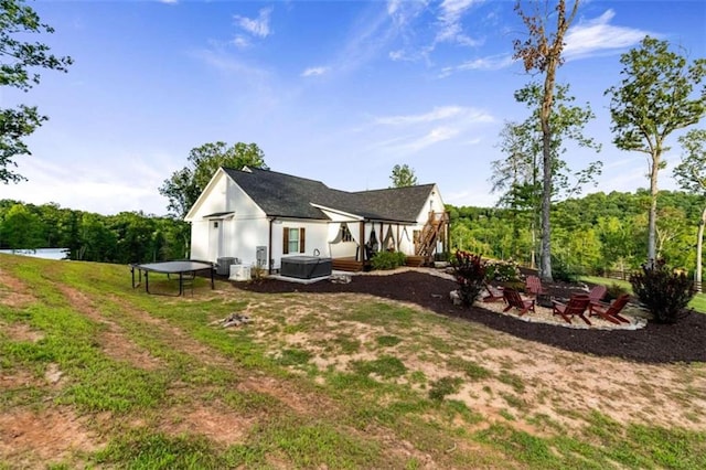 rear view of house featuring a patio area, an outdoor fire pit, and central AC unit