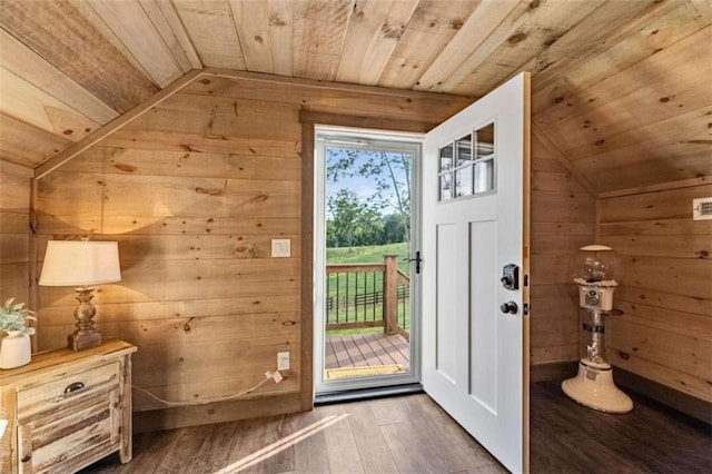 doorway featuring wood walls, vaulted ceiling, dark hardwood / wood-style floors, and wooden ceiling