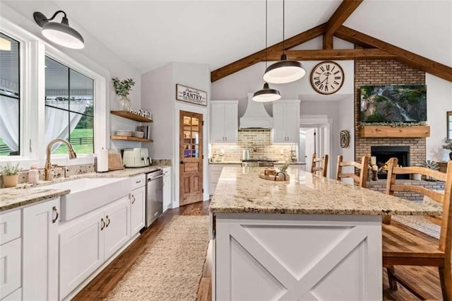 kitchen featuring dark wood-type flooring, white cabinetry, and hanging light fixtures