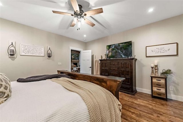 bedroom featuring ceiling fan and dark hardwood / wood-style floors