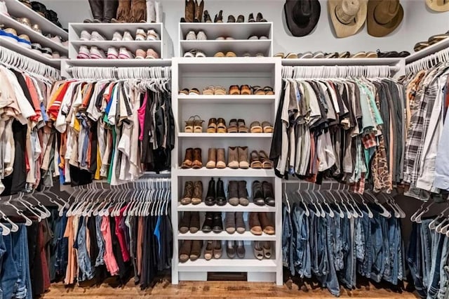 walk in closet with hardwood / wood-style floors