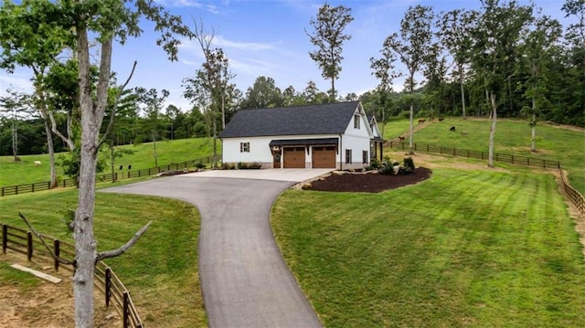 view of front of home featuring a front yard and a rural view