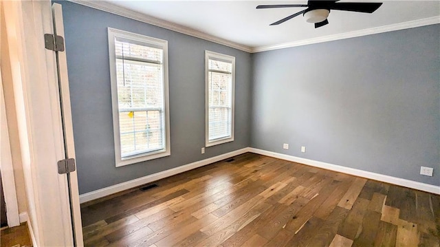 unfurnished room featuring crown molding, dark wood-type flooring, ceiling fan, and a healthy amount of sunlight