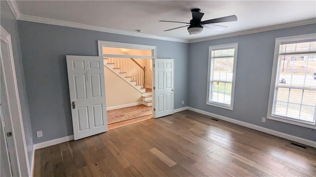 unfurnished bedroom with wood-type flooring, connected bathroom, ceiling fan, and crown molding