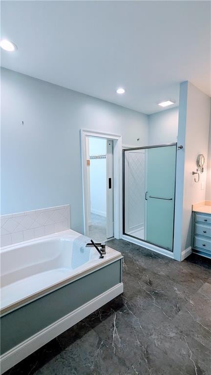 bathroom featuring separate shower and tub and vanity