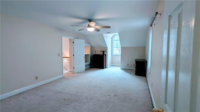 bonus room with light colored carpet, vaulted ceiling, and ceiling fan