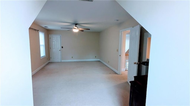 carpeted spare room featuring ceiling fan