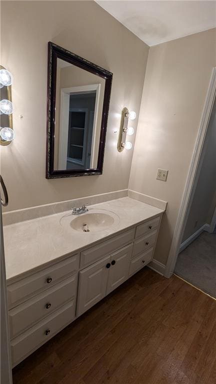 bathroom with hardwood / wood-style floors and vanity