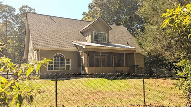 view of front of house with a sunroom and a front yard