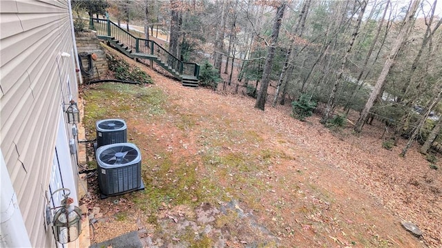 view of yard featuring central air condition unit