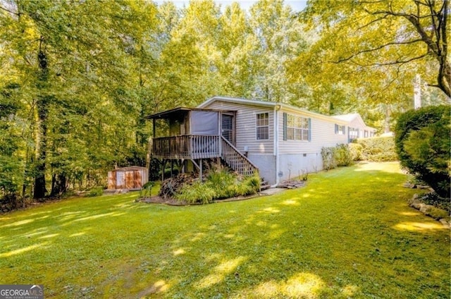 view of front of property with a front yard and a deck