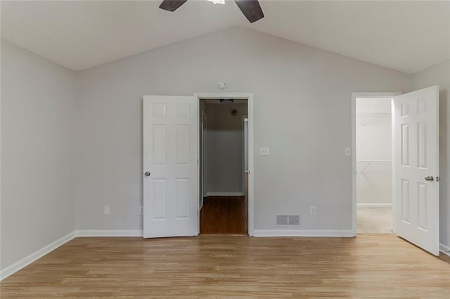 3614 Spring Leaf Ln, Acworth, GA 30101 - unfurnished bedroom with a spacious closet, light wood-type flooring, lofted ceiling, a closet, and a ceiling fan