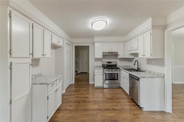 3614 Spring Leaf Ln, Acworth, GA 30101 - kitchen featuring stainless steel appliances, under cabinet range hood, light countertops, white cabinetry, and a textured ceiling