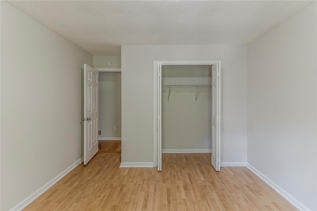 3614 Spring Leaf Ln, Acworth, GA 30101 - unfurnished bedroom featuring light wood-type flooring, a closet, and a textured ceiling