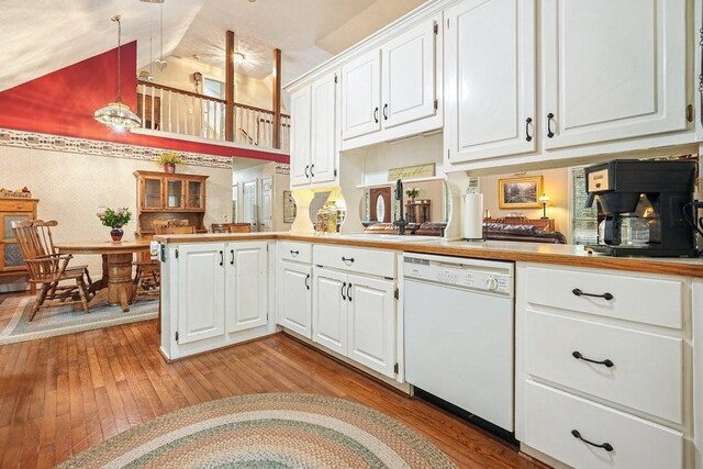 kitchen featuring light hardwood / wood-style floors, dishwasher, decorative light fixtures, and white cabinets