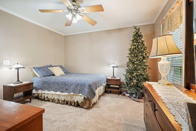 bedroom with ceiling fan, crown molding, and carpet floors