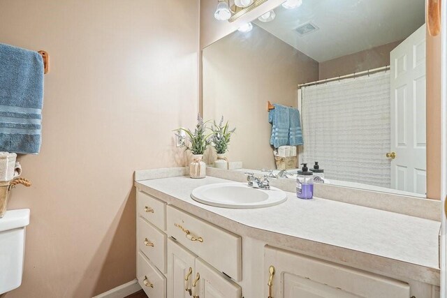 bathroom with vanity and toilet