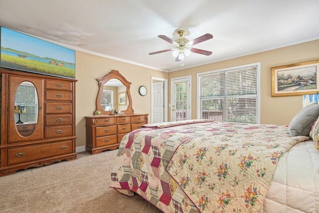 carpeted bedroom featuring crown molding and ceiling fan