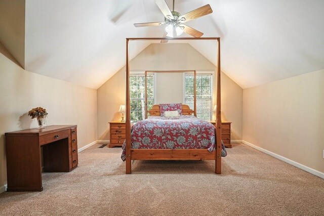 bedroom with vaulted ceiling, light colored carpet, and ceiling fan