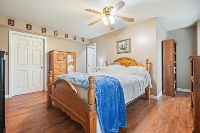 bedroom with wood-type flooring and ceiling fan