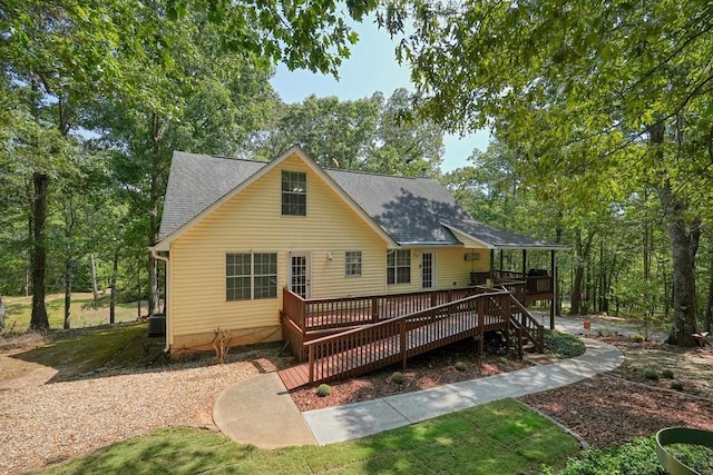 rear view of property featuring a wooden deck