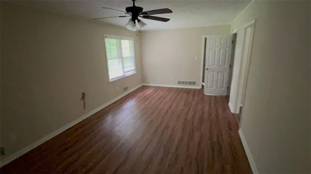 5924 Central Church Rd, Douglasville, GA 30135 - unfurnished bedroom featuring dark wood-style flooring, baseboards, and a ceiling fan