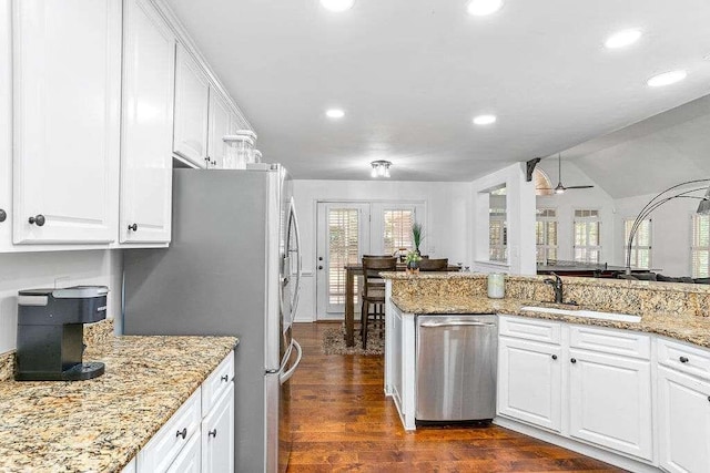 kitchen featuring appliances with stainless steel finishes, white cabinetry, and dark hardwood / wood-style flooring