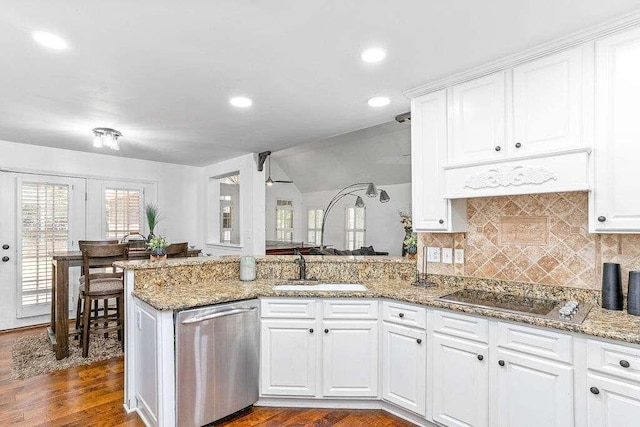 kitchen with black electric stovetop, wood-type flooring, kitchen peninsula, white cabinetry, and stainless steel dishwasher