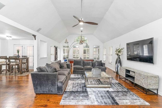 living room with dark wood-type flooring, ceiling fan, and lofted ceiling