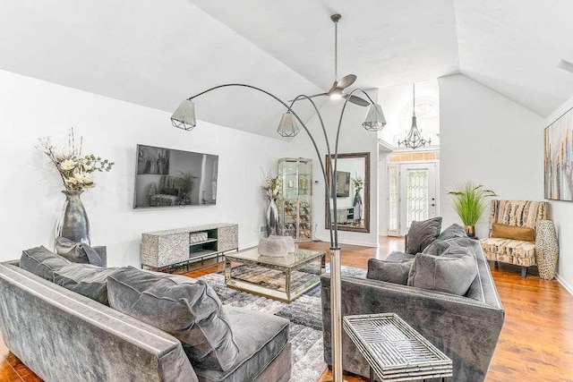 living room with lofted ceiling, hardwood / wood-style floors, and ceiling fan