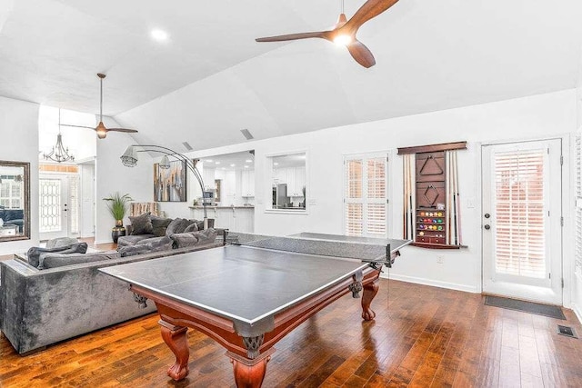 rec room with dark hardwood / wood-style floors, ceiling fan with notable chandelier, and vaulted ceiling