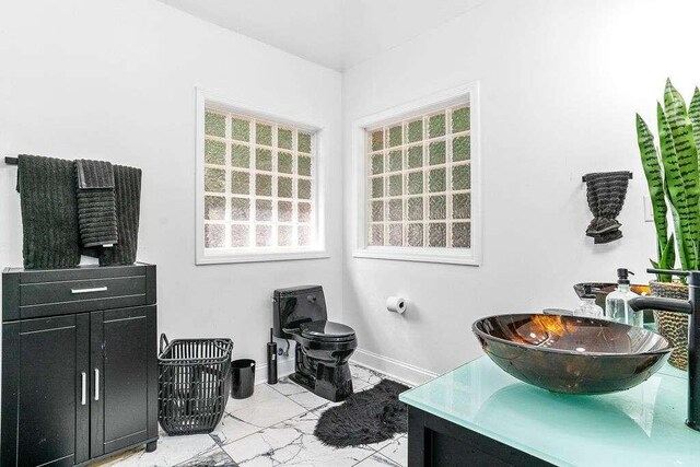 bathroom featuring vanity and toilet