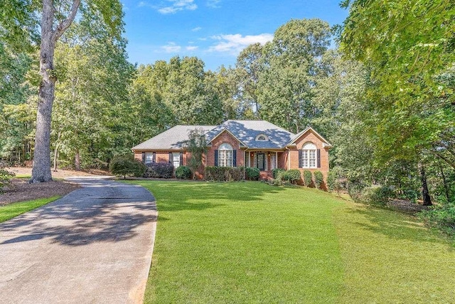 ranch-style home with a front lawn