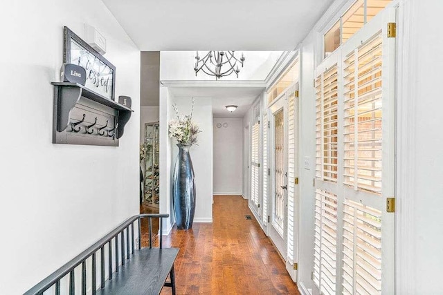 hall featuring french doors, a chandelier, and dark hardwood / wood-style floors