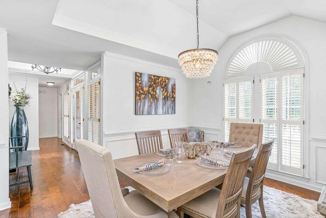 dining space featuring vaulted ceiling, a chandelier, and dark hardwood / wood-style floors