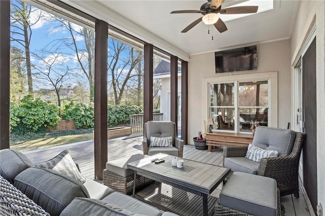 sunroom / solarium with ceiling fan, outdoor lounge area, and plenty of natural light