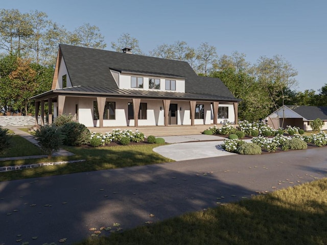 view of front of house featuring a standing seam roof, a porch, and metal roof