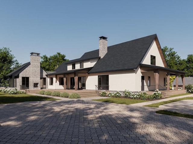 view of front facade with a porch and a chimney