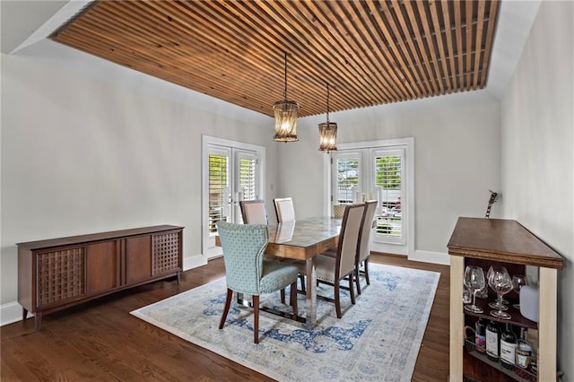 dining room with french doors, baseboards, and dark wood-type flooring