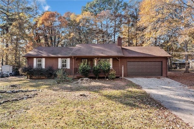 single story home featuring a garage and a front lawn