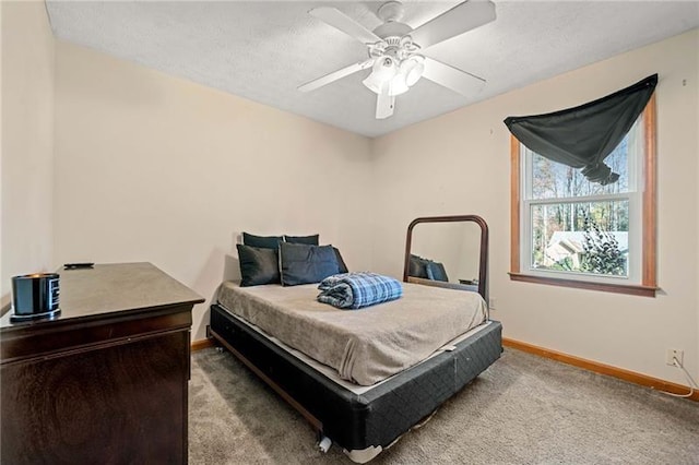 bedroom featuring a textured ceiling, ceiling fan, and carpet