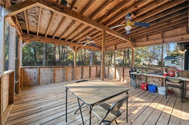 wooden deck featuring an outdoor bar and ceiling fan