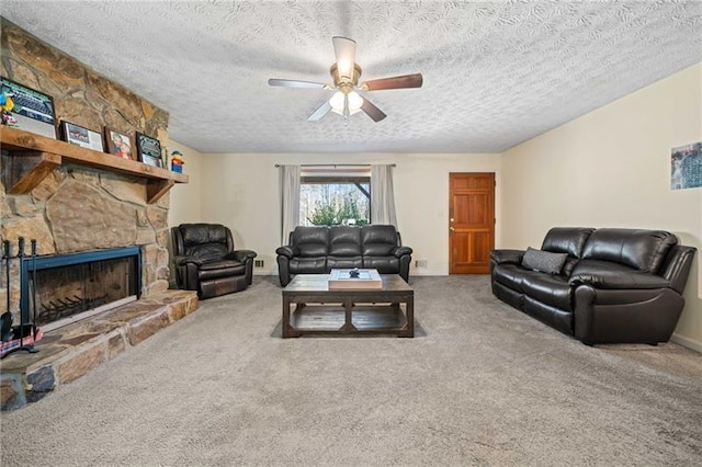 living room with carpet floors, a textured ceiling, a fireplace, and ceiling fan