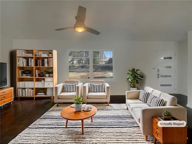 living room featuring a ceiling fan and wood finished floors