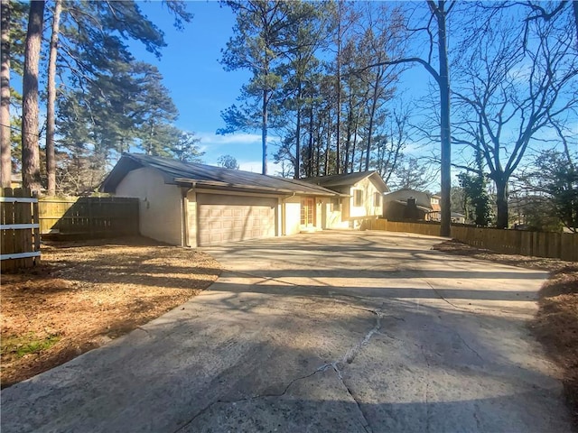 2217 Troutdale Dr, Decatur, GA 30032 - view of property exterior featuring a garage, driveway, and fence