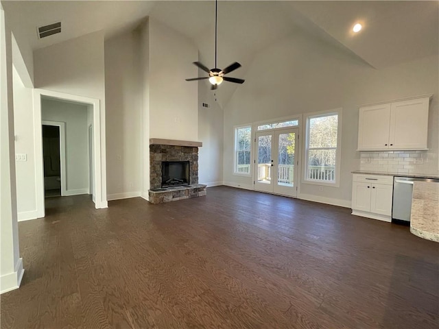 3605 Garden Lakes Pkwy NW, Rome, GA 30165 - unfurnished living room featuring a ceiling fan, baseboards, a stone fireplace, dark wood-style flooring, and high vaulted ceiling