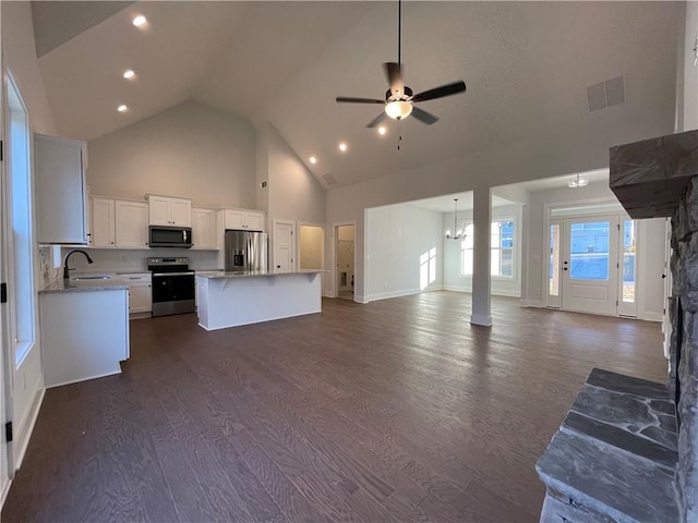 3605 Garden Lakes Pkwy NW, Rome, GA 30165 - unfurnished living room with high vaulted ceiling, a sink, dark wood-style floors, a ceiling fan, and a chandelier