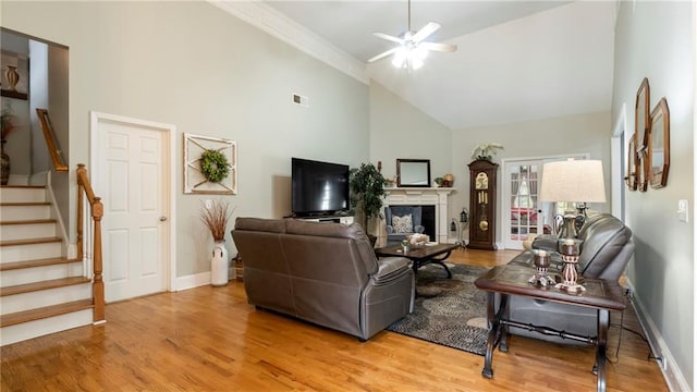 living room featuring ceiling fan, hardwood / wood-style floors, and high vaulted ceiling